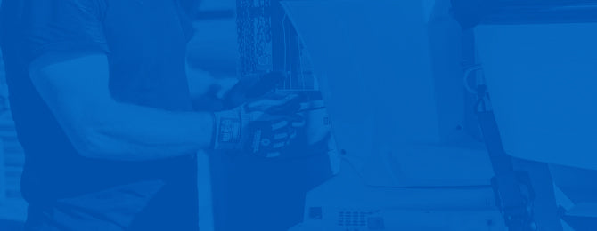 Boat mechanic working on engine on blue background